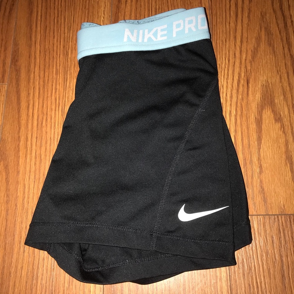 black nike pros with blue band